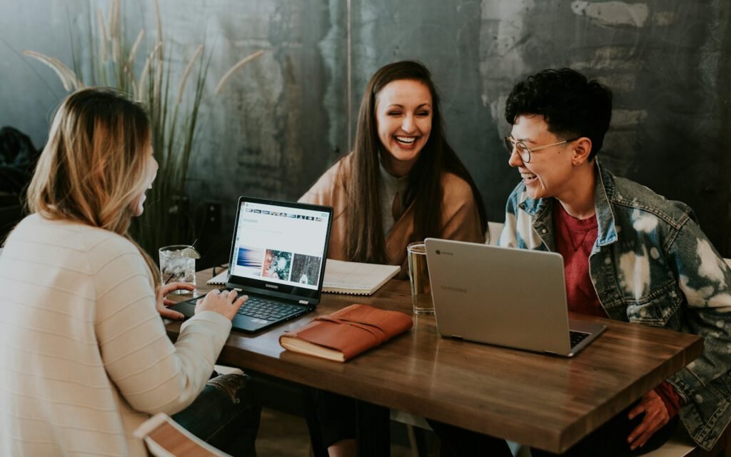Two people reviewing a project together on a laptop
