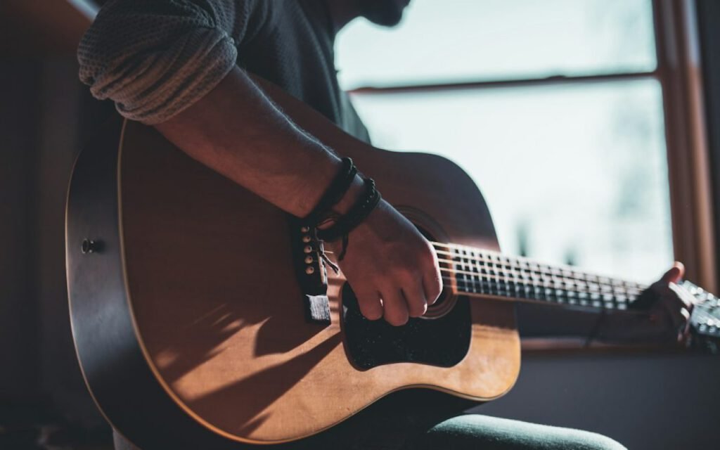 An acoustic guitar resting against a chair