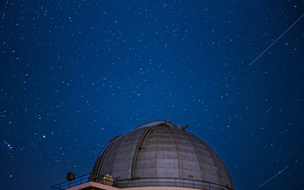 An observatory dome under a starry night sky
