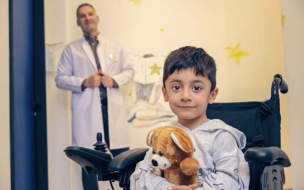 A young child holding a teddy bear during a medical visit