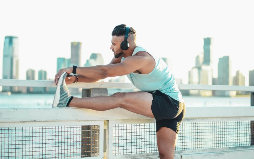 Person stretching outdoors on a city sidewalk