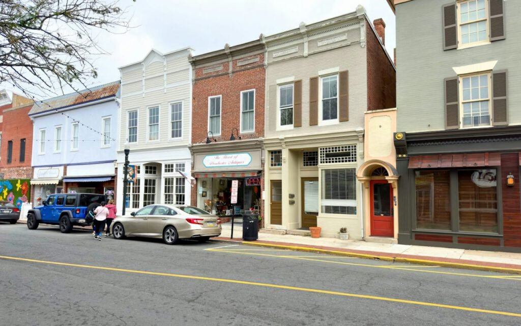 Quiet main street with shops and trees on a sunny day