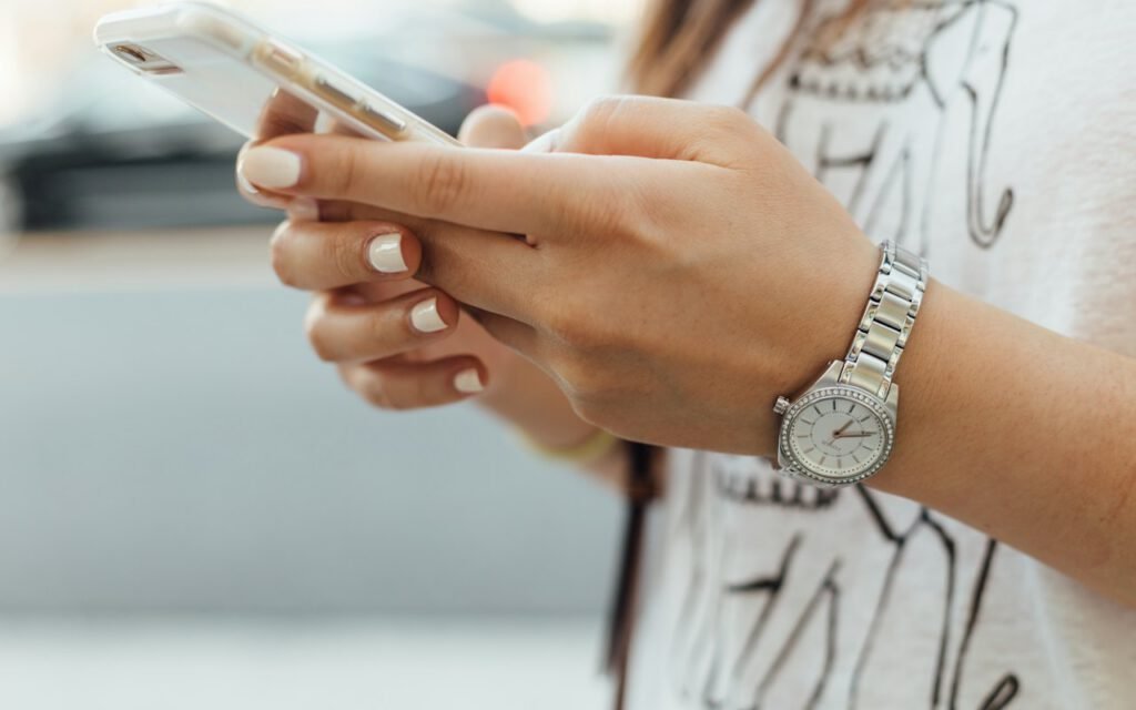 Hands holding a smartphone while scrolling a feed