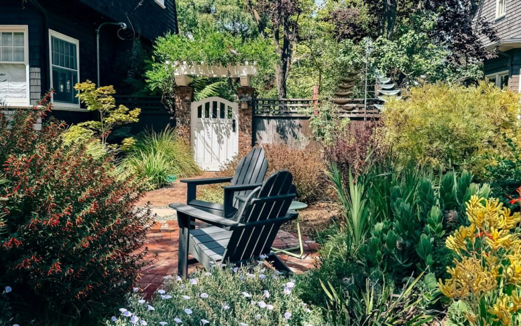 Two chairs set out in a green garden