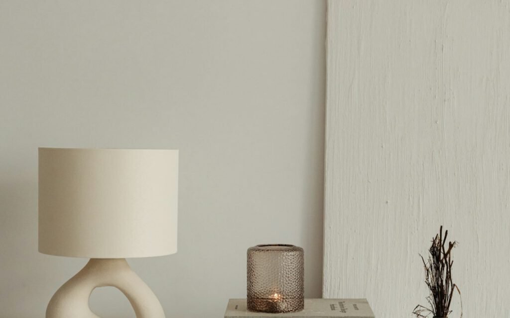 A table lamp beside a stack of books