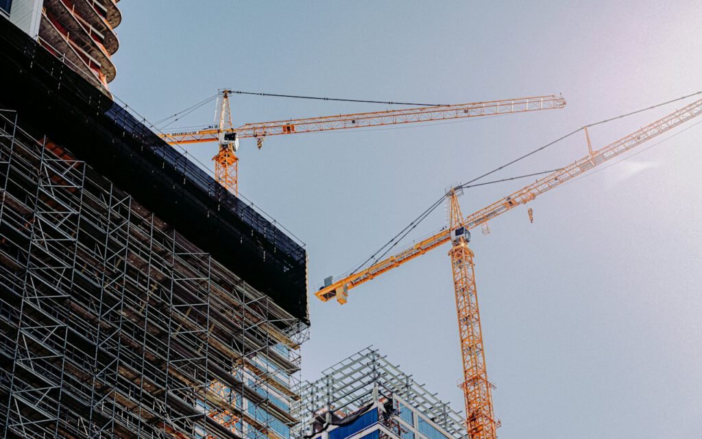A construction crane lifting materials over a building site