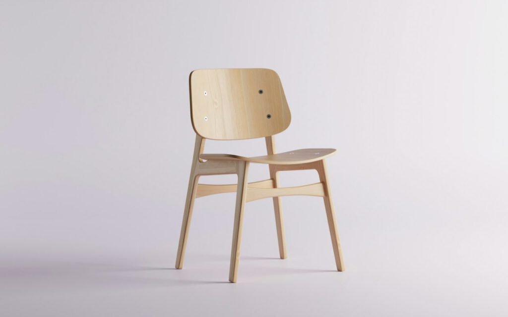 A simple wooden dining chair against a white wall