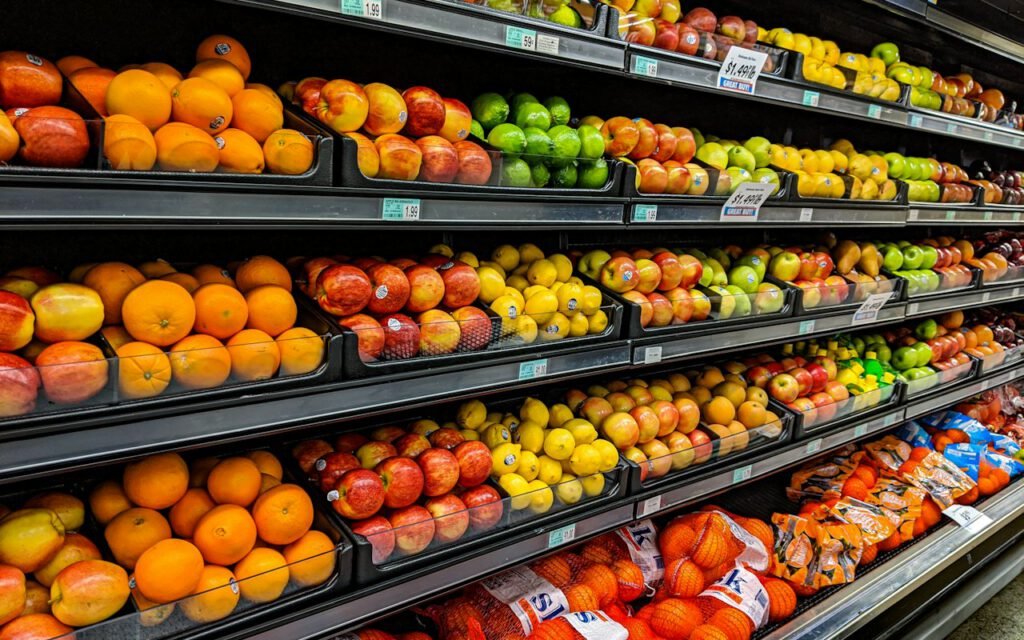 Fresh vegetables and fruit displayed in a grocery store produce section