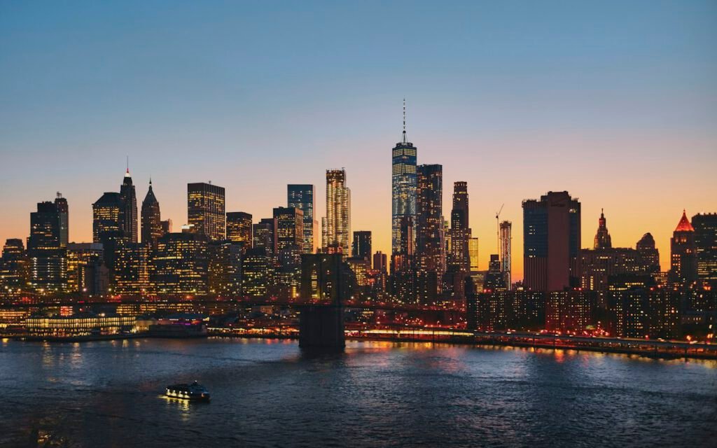 A dense city skyline at dusk with many flat rooftops