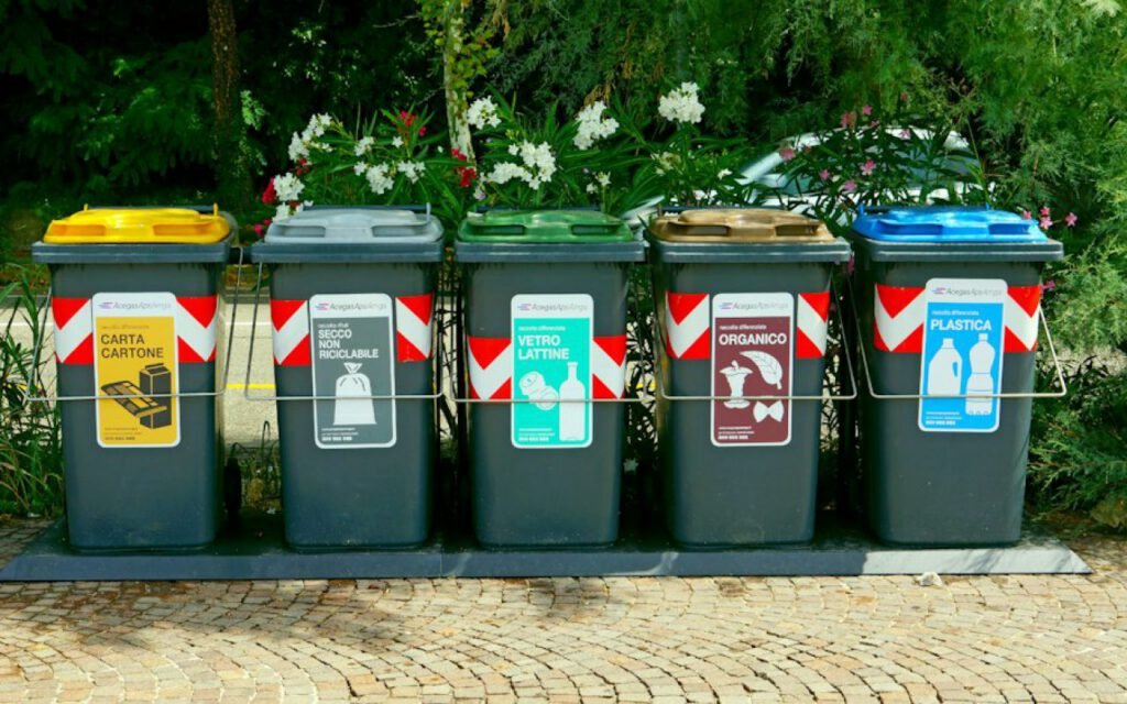 Colored recycling bins lined up outdoors