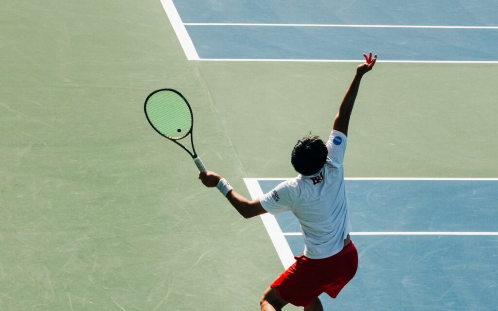 A tennis player swinging a racket on an outdoor court