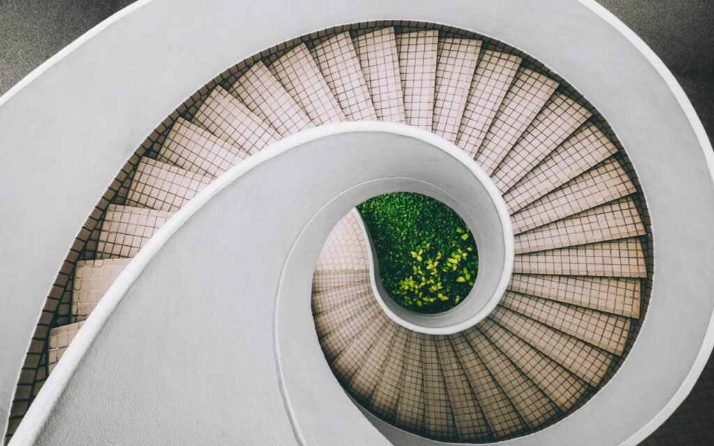 A curving wooden staircase seen from below