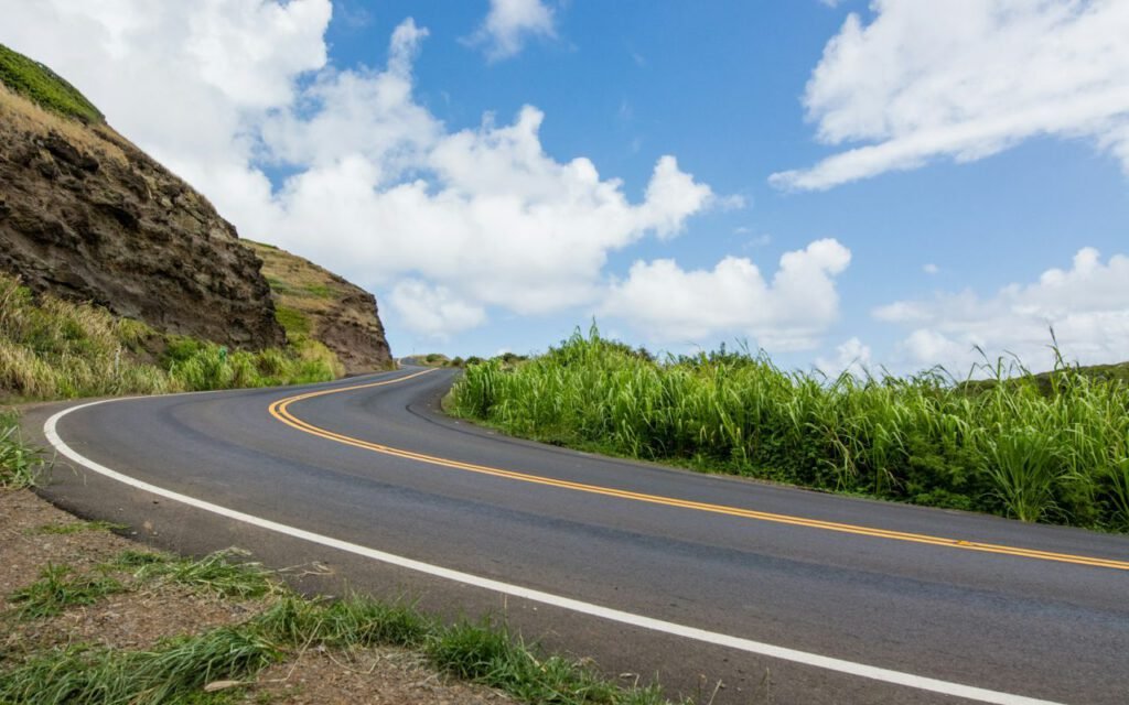A two-lane road curving through open countryside