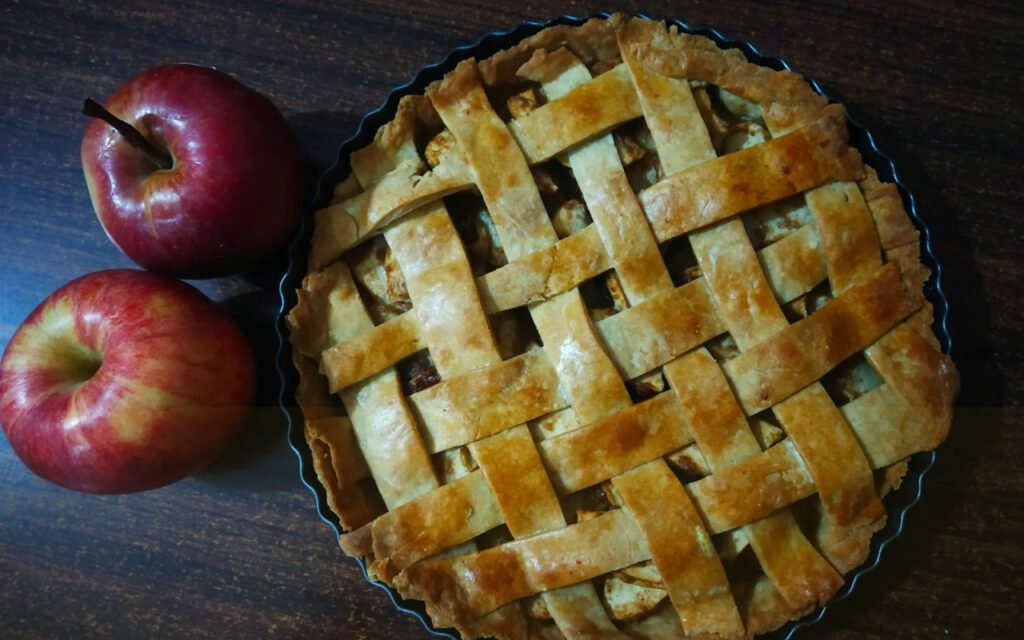 A golden homemade pie on a wooden table