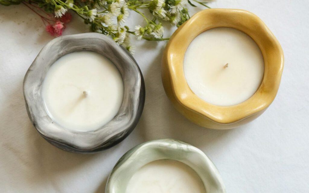 Several lit candles glowing softly in a dark room