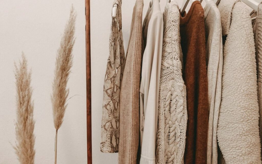 Clothing rack with neutral and soft colored garments