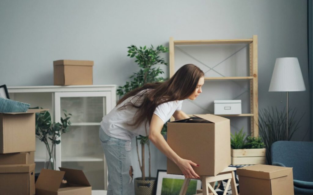 Clothes and small items being packed into a bag
