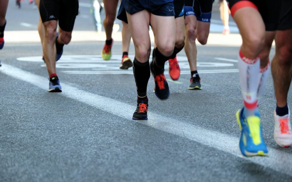 A large group of runners on a city street during a race