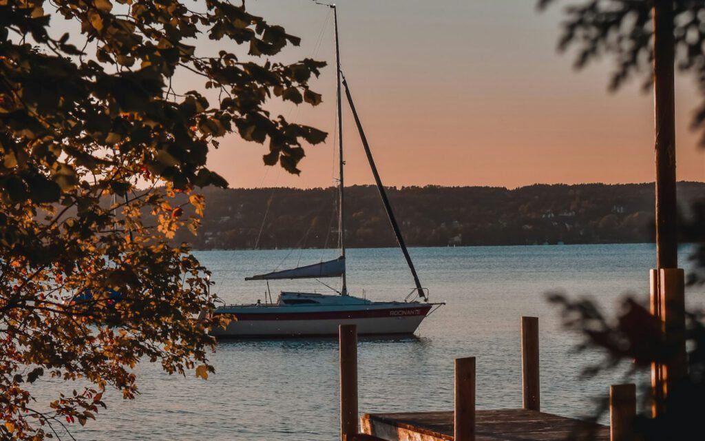 Single sailboat on calm water near the coast