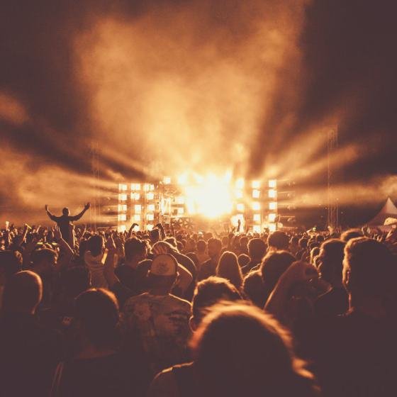 A lit stage with performers in front of an audience