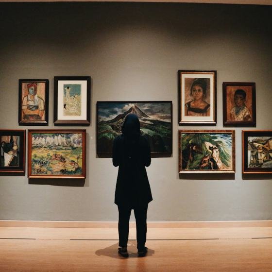Framed artwork hanging on the white walls of a gallery