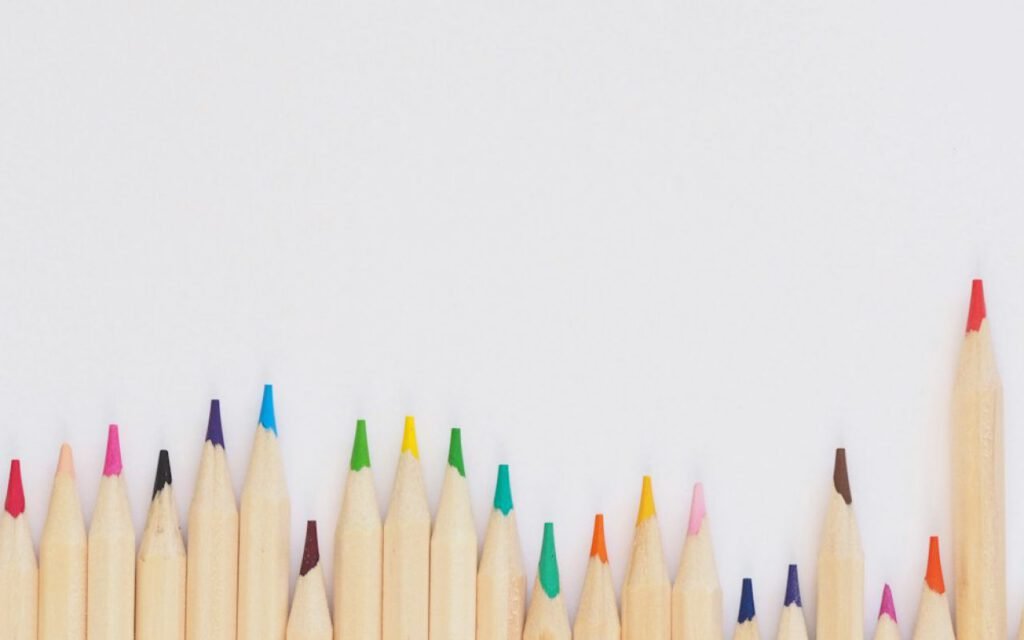 A spread of colored pencils on a drawing table