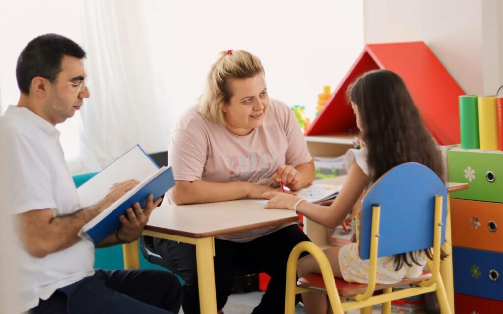A parent and child reading a picture book together on a couch