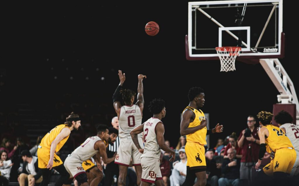A high school player shooting a free throw in a crowded gym