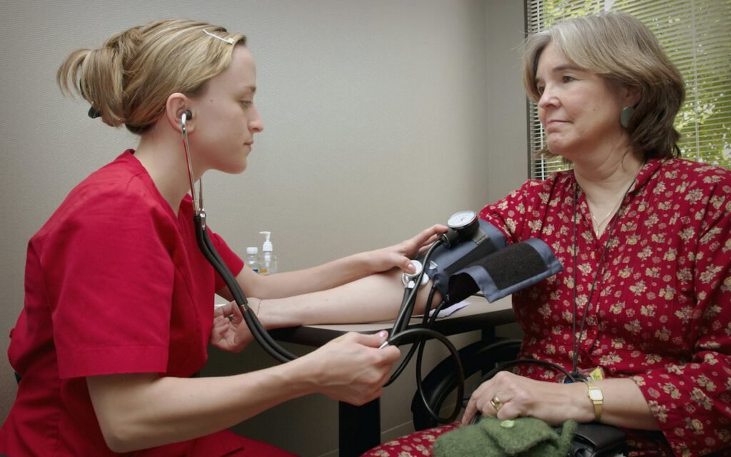 A doctor talking with a patient in an exam room