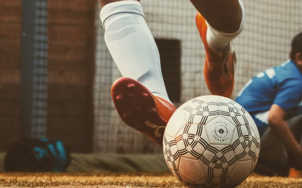 A soccer player striking the ball during a match