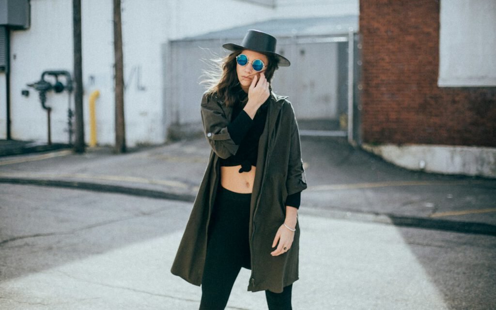 A stylish woman walking outdoors wearing layered accessories