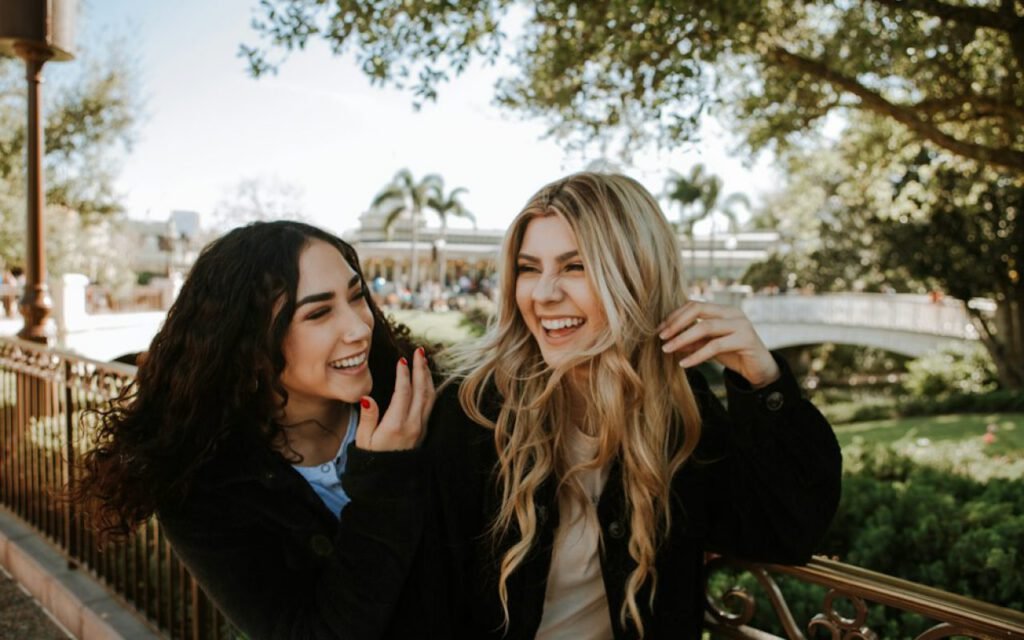 Two friends talking on a park bench