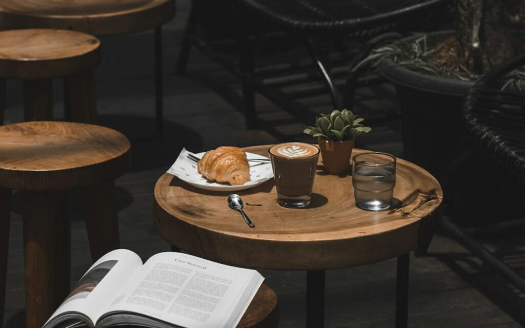 Open secondhand book next to a coffee cup