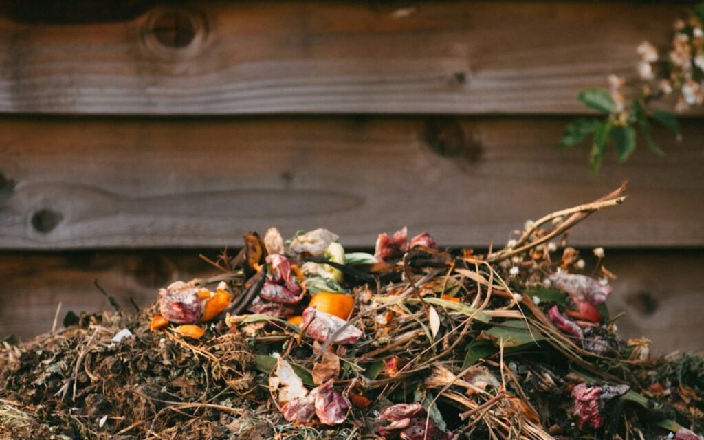A compost bin filled with food scraps and dry leaves