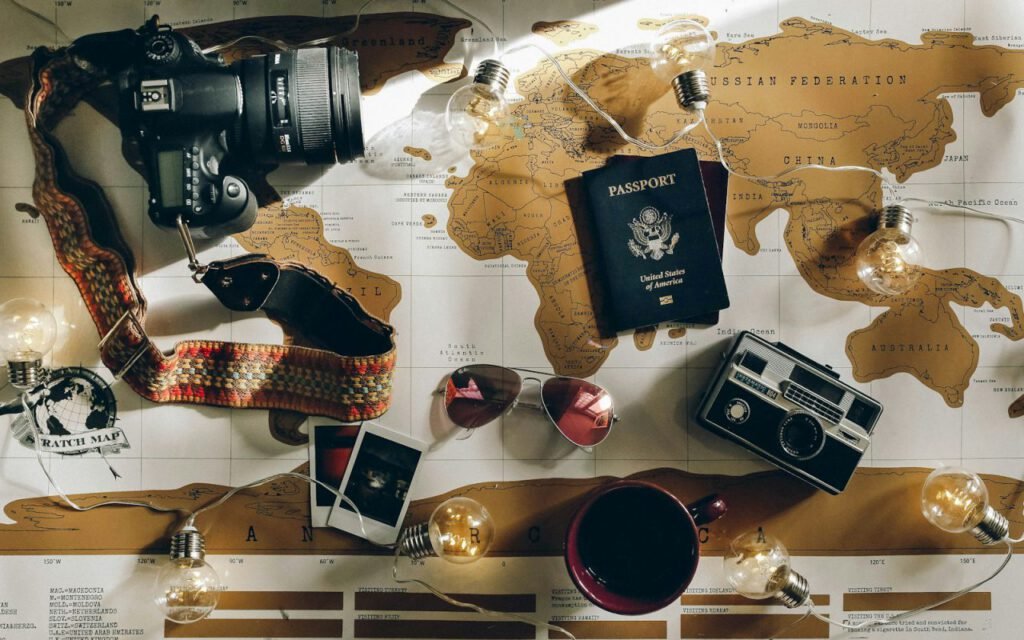 A camera and travel documents laid out on a table