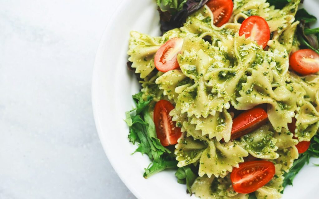 Bowl of pasta tossed with green pesto