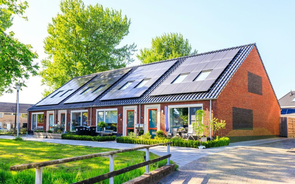 Solar panels on the roofs of a row of neighboring houses