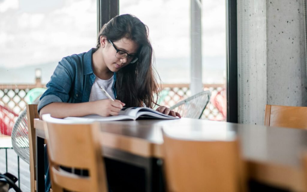A teenager studying at a desk at home