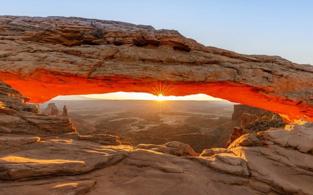 Red rock arches in the Utah desert under a clear sky