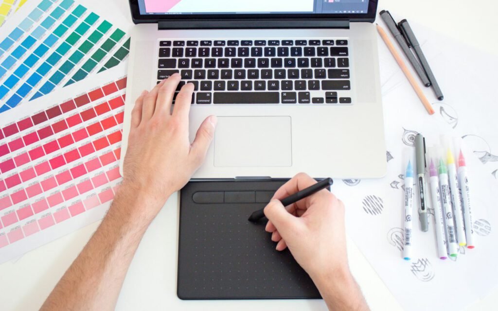 A designer working on interface layouts on a tablet