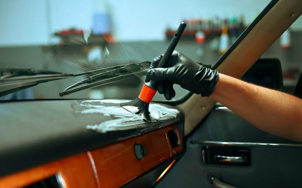 A brush being used to clean an interior surface
