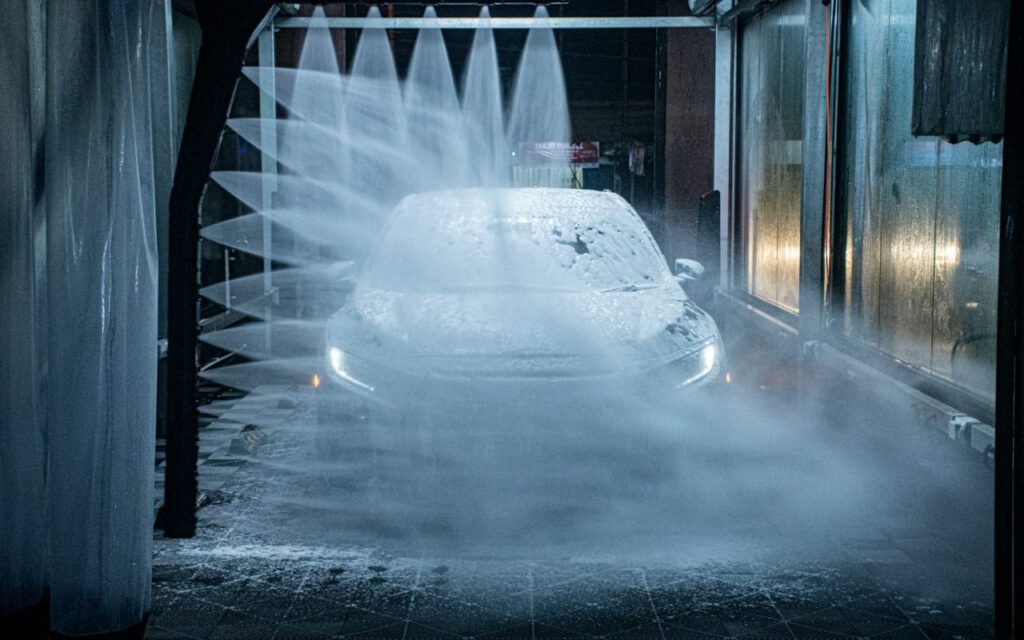 Car moving through an automatic wash tunnel