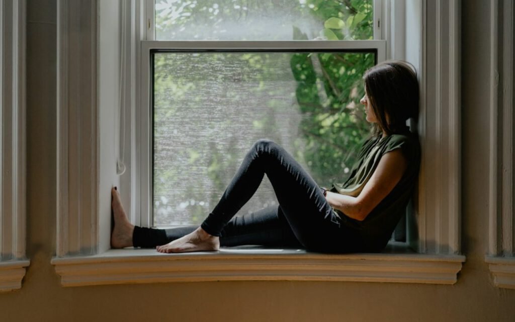Person reading a book by a bright window