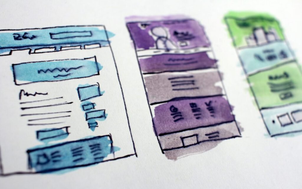 Hand-drawn wireframes laid out on a table
