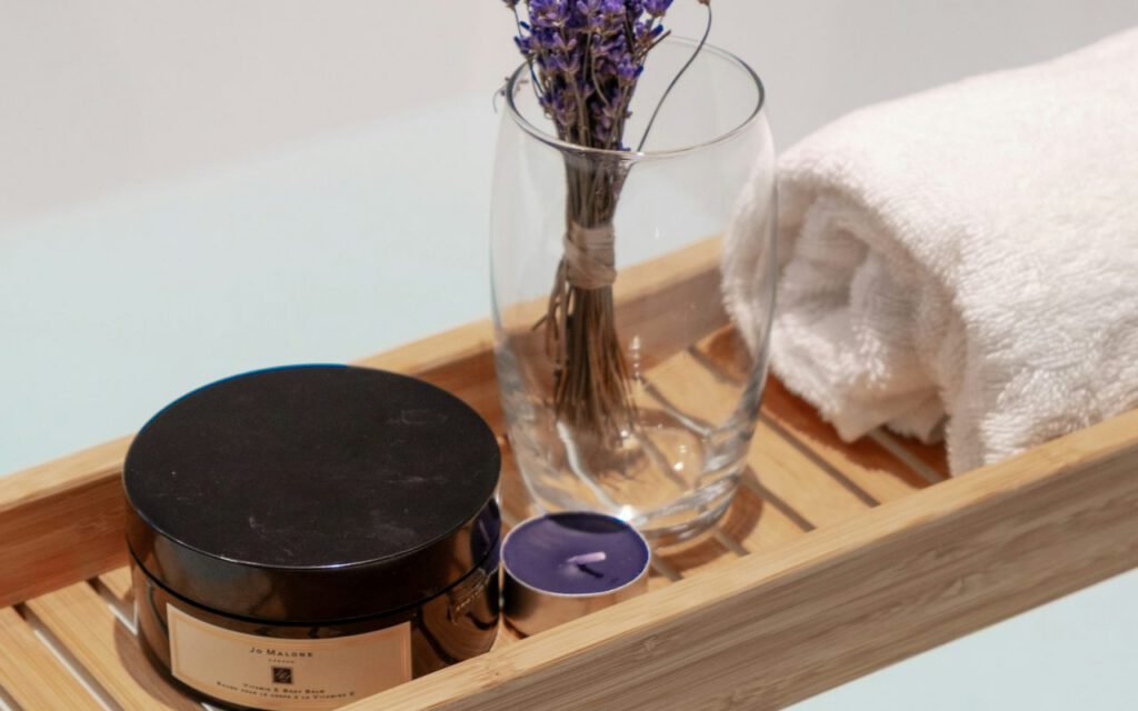 Bath tray with a book and candle resting across a bathtub