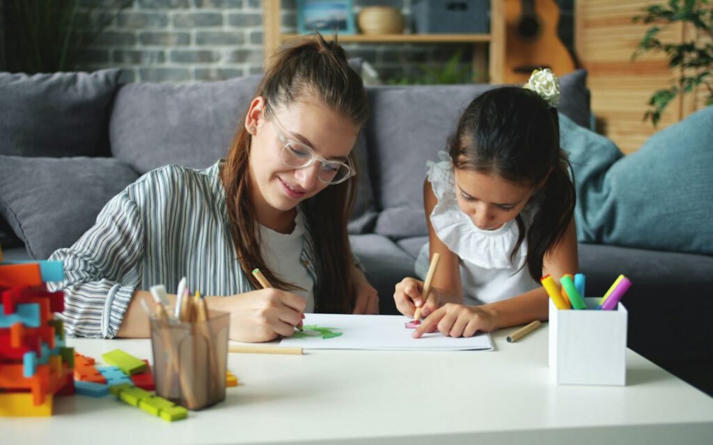 Children sitting at a table working on a craft project together