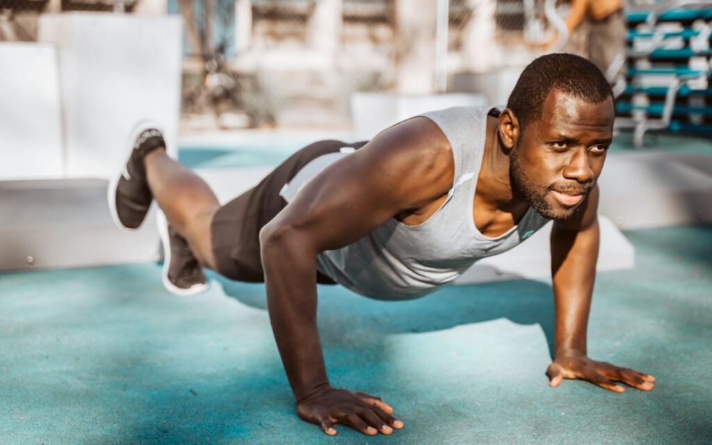 A person doing a push-up on an exercise mat at home