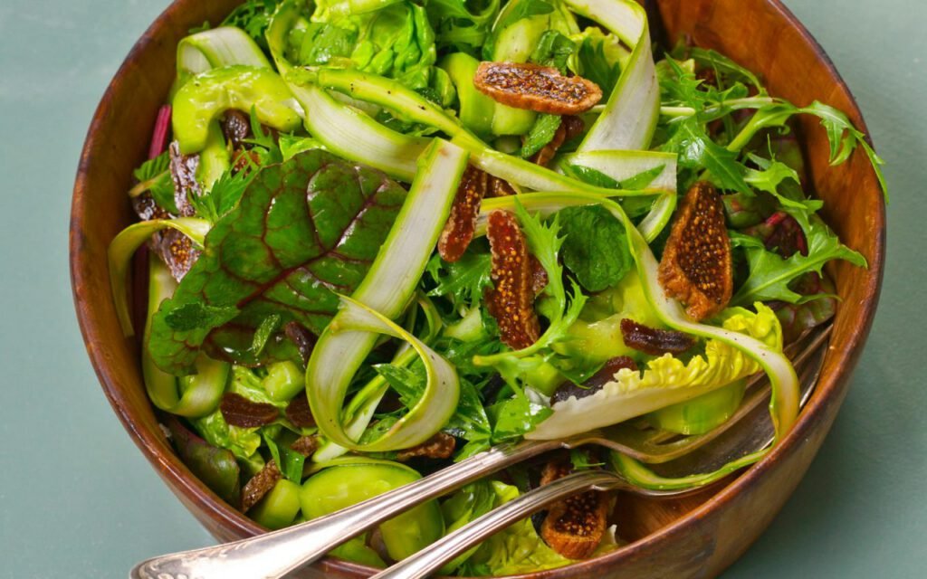 A fresh salad served in a wooden bowl on a table