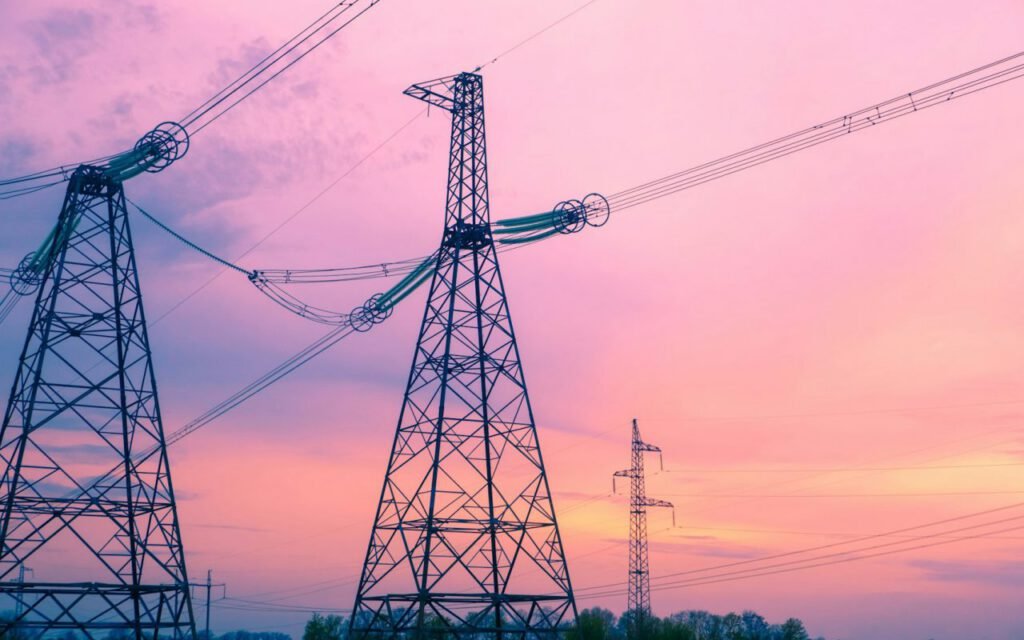 Power lines running along a residential street at dusk