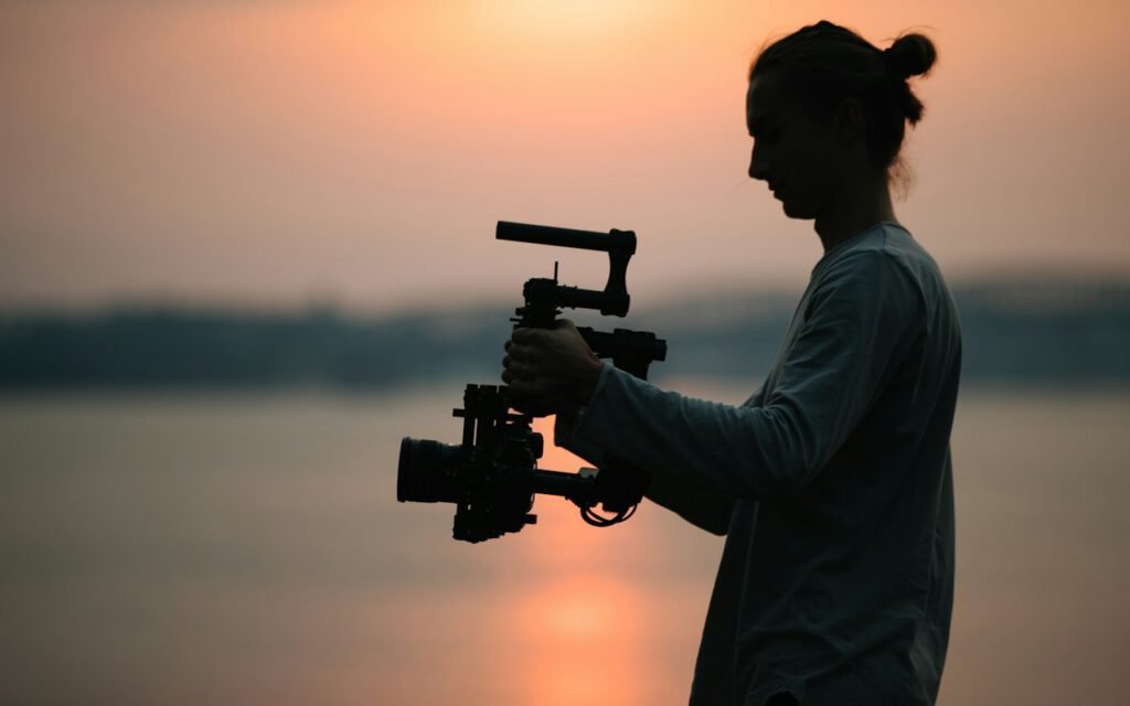 A camera operator filming with a handheld cinema camera